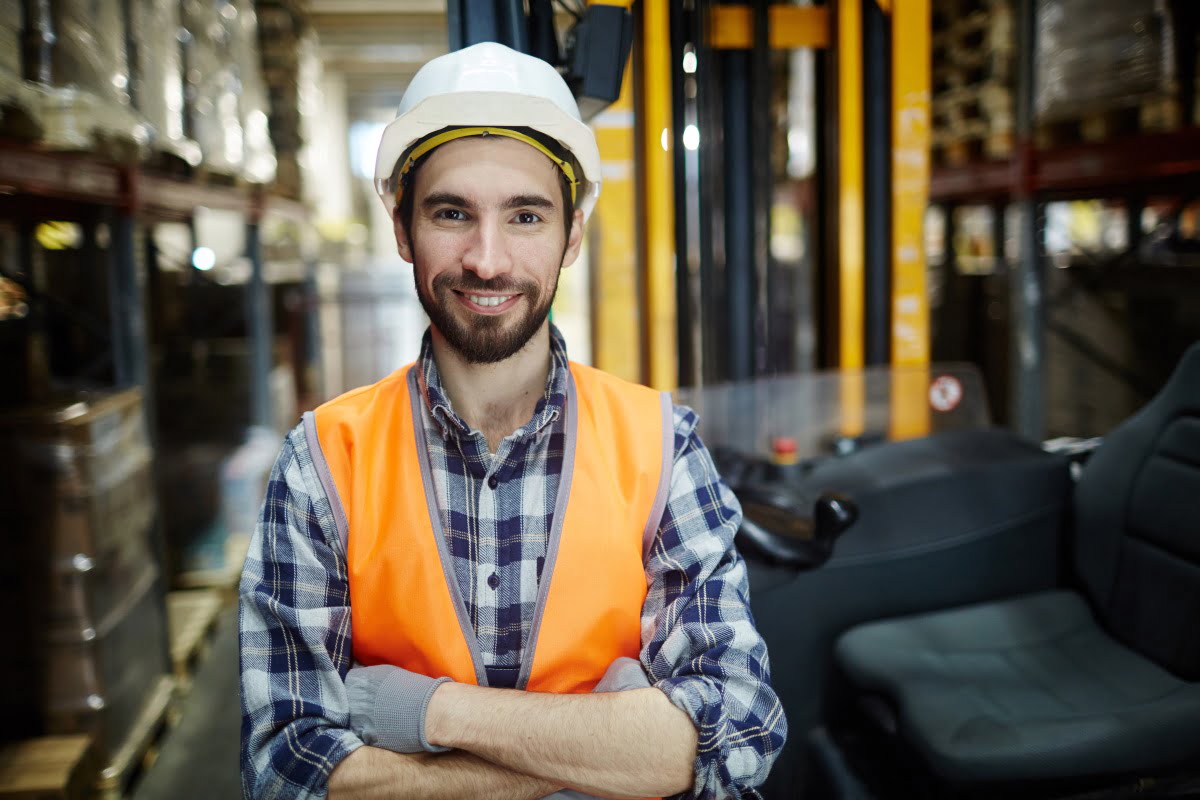 happy-men-with-tablet-pc-and-forklift-at-warehouse-PR2CLBG
