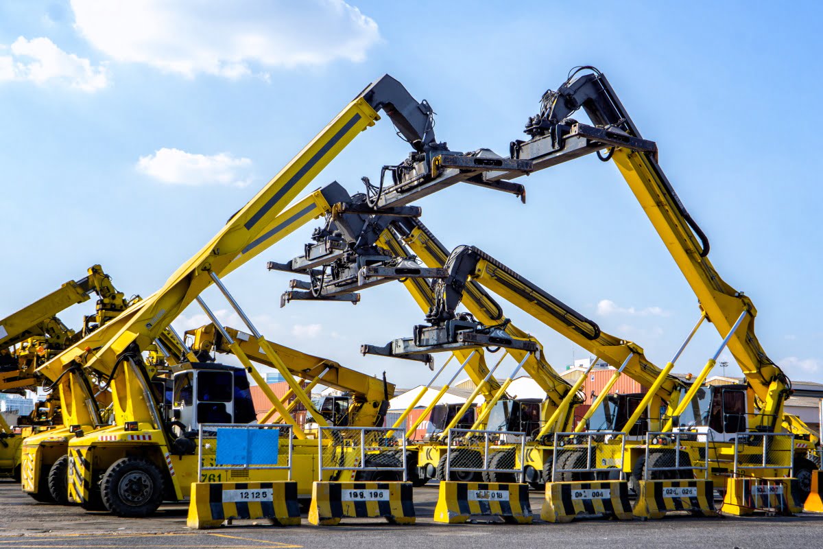 happy-men-with-tablet-pc-and-forklift-at-warehouse-PR2CLBG