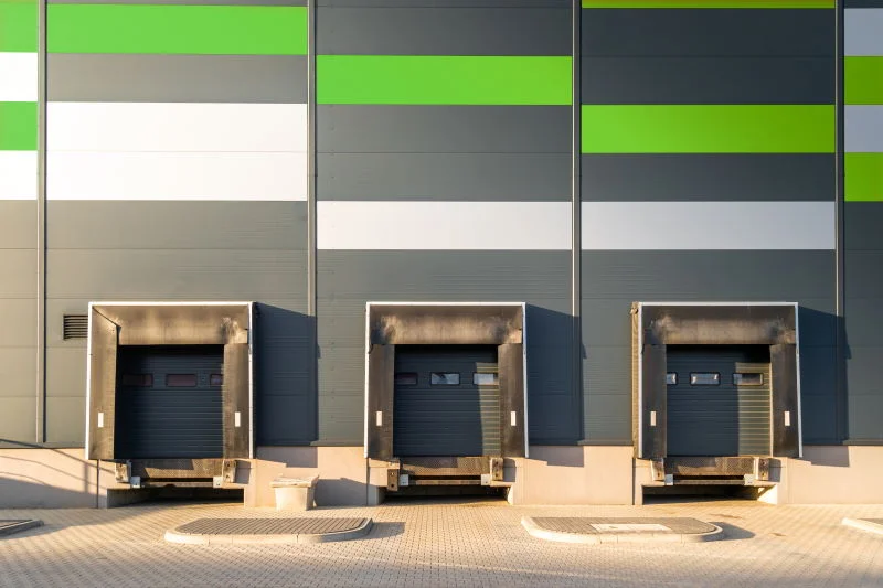 cargo-loading-dock-doors-of-big-warehouse-building-XAX5AUP Is Your Warehouse Safe For Workers? blog post featured image