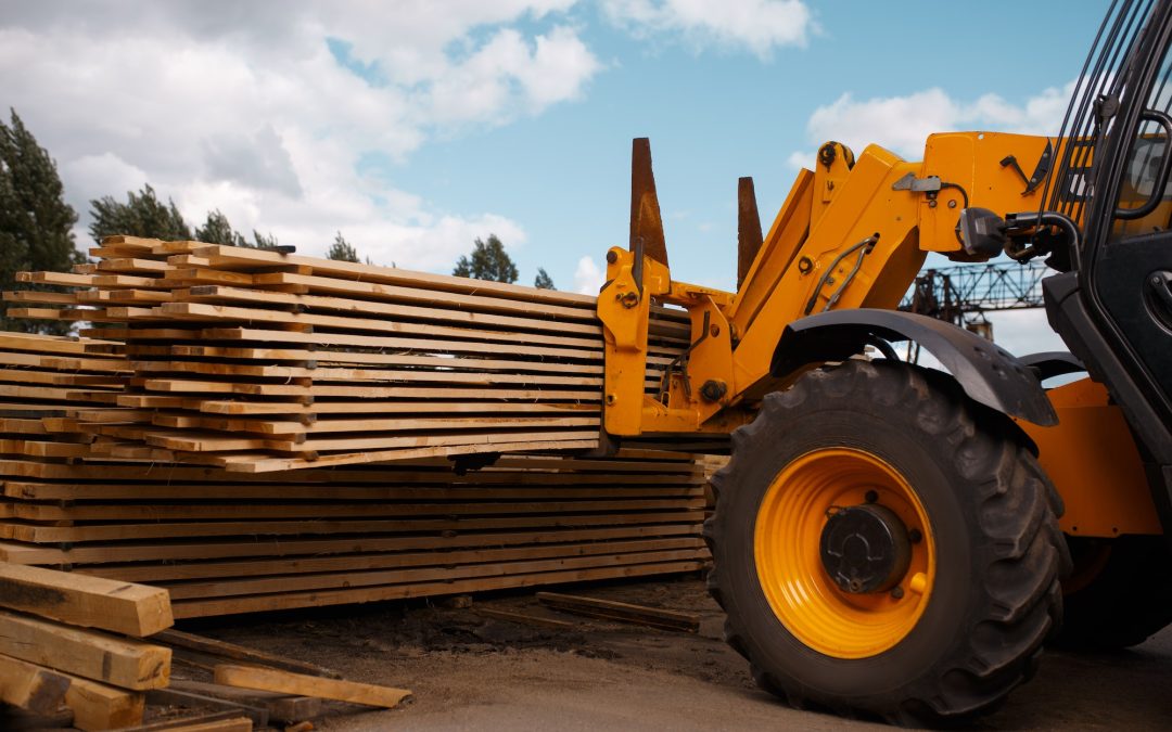 Forklift loads the boards in the lumber yard