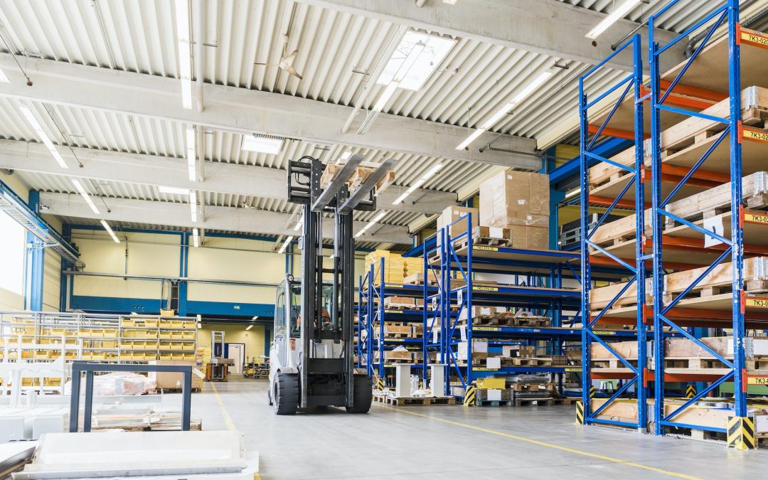 Man on forklift in factory warehouse