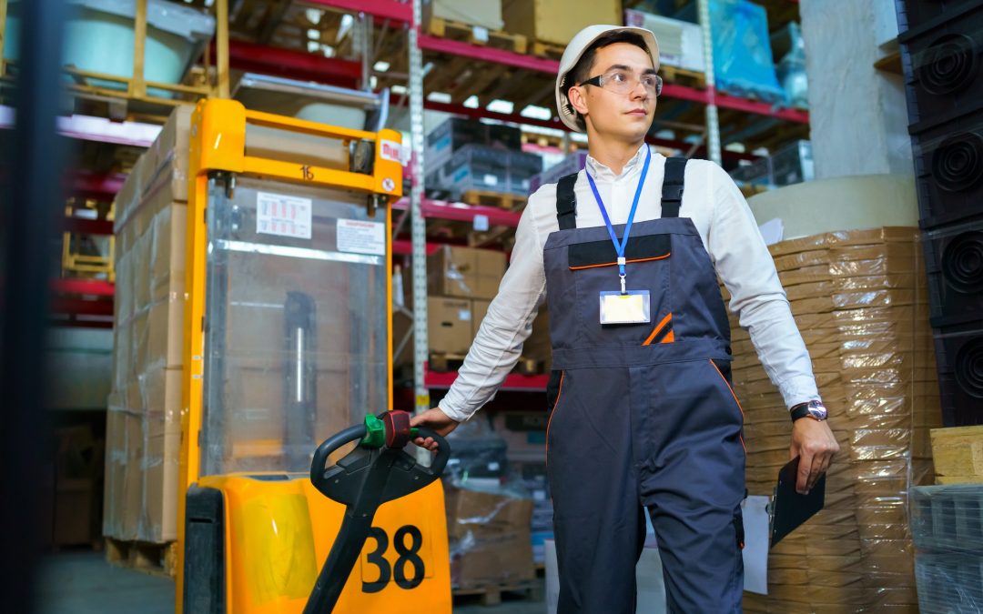 Man works in a warehouse with a forklift