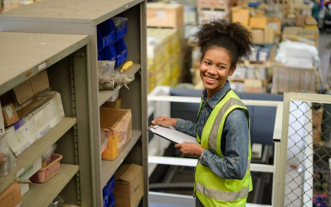 Female warehouse worker Counting items in an industrial warehouse