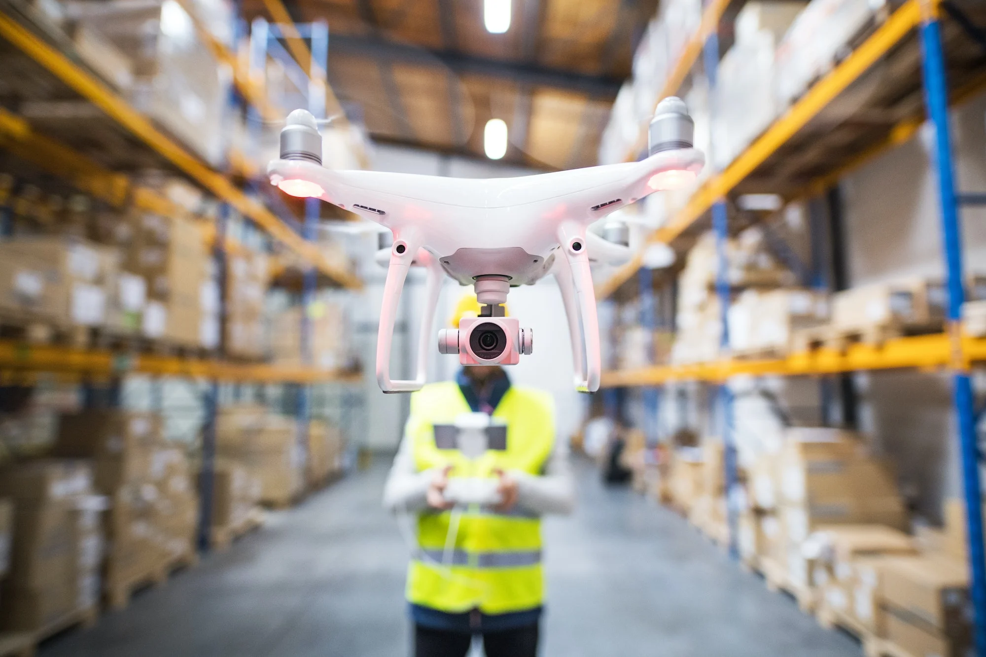 Man with drone in a warehouse. Automating Your Warehouse: How Robotic Systems Impact Layout Design and Evaluation