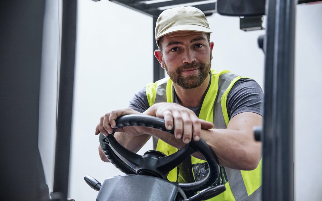 Portrait of confident man on forklift