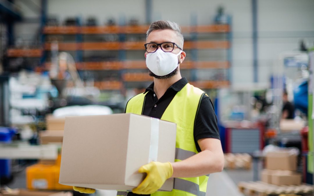 Man worker with protective mask working in industrial factory or warehouse