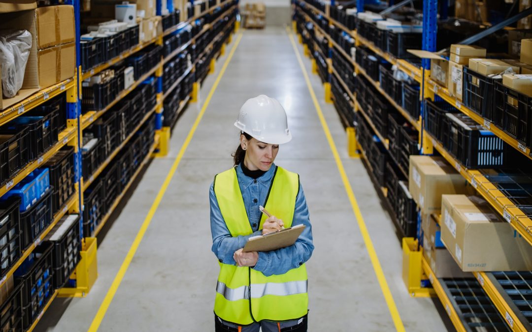 Warehouse female worker checking up stuff in a warehouse.