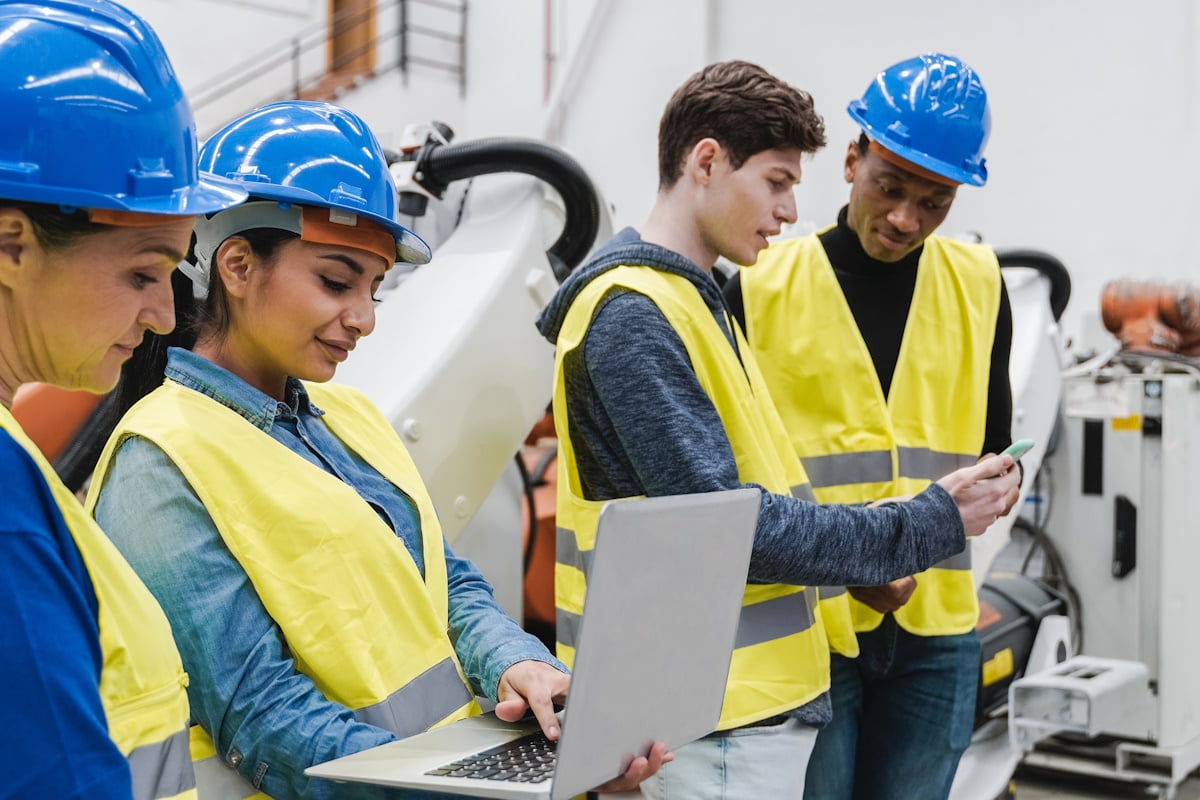 happy-men-with-tablet-pc-and-forklift-at-warehouse-PR2CLBG