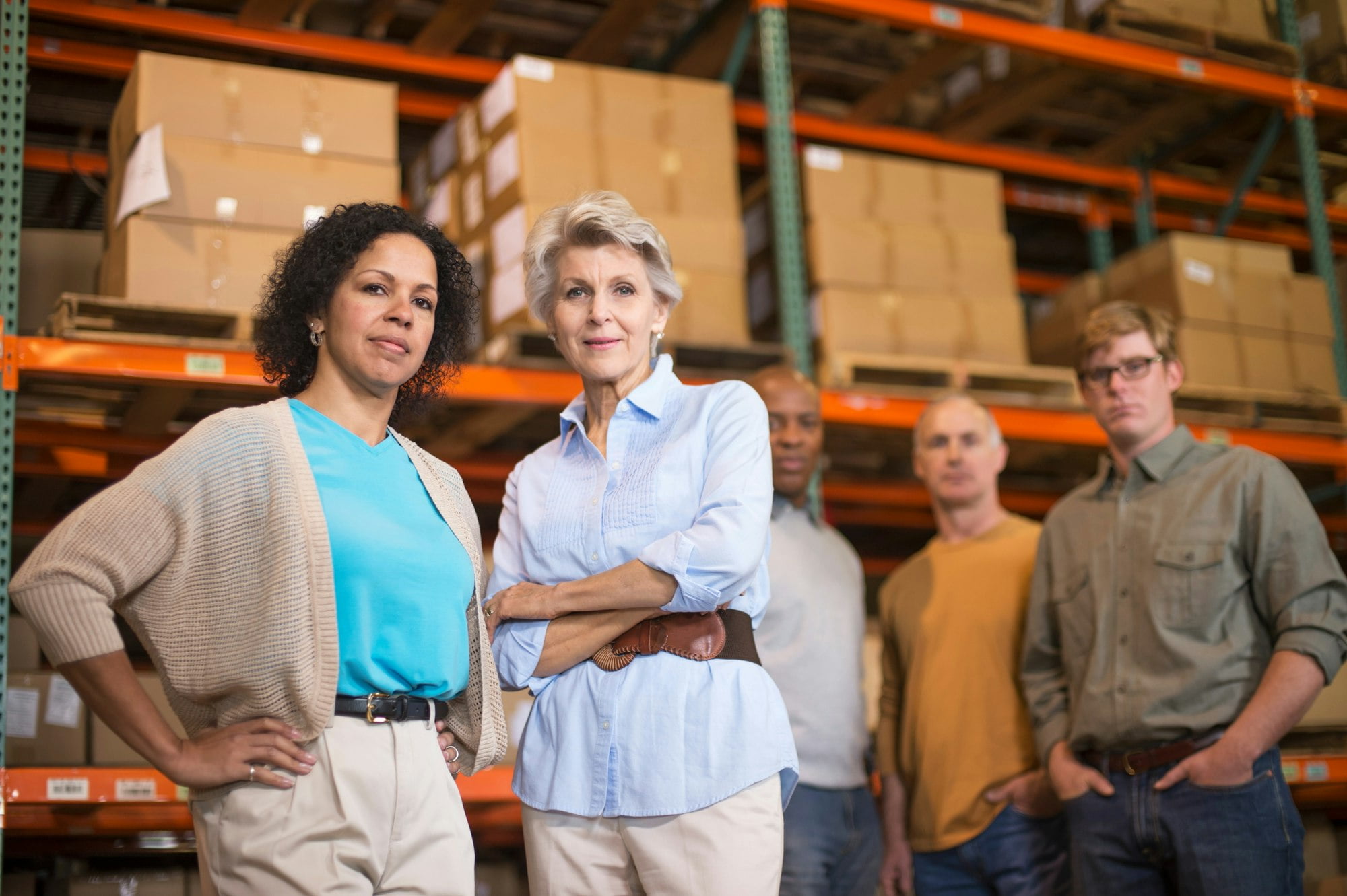 Portrait of warehouse workers in front of boxes