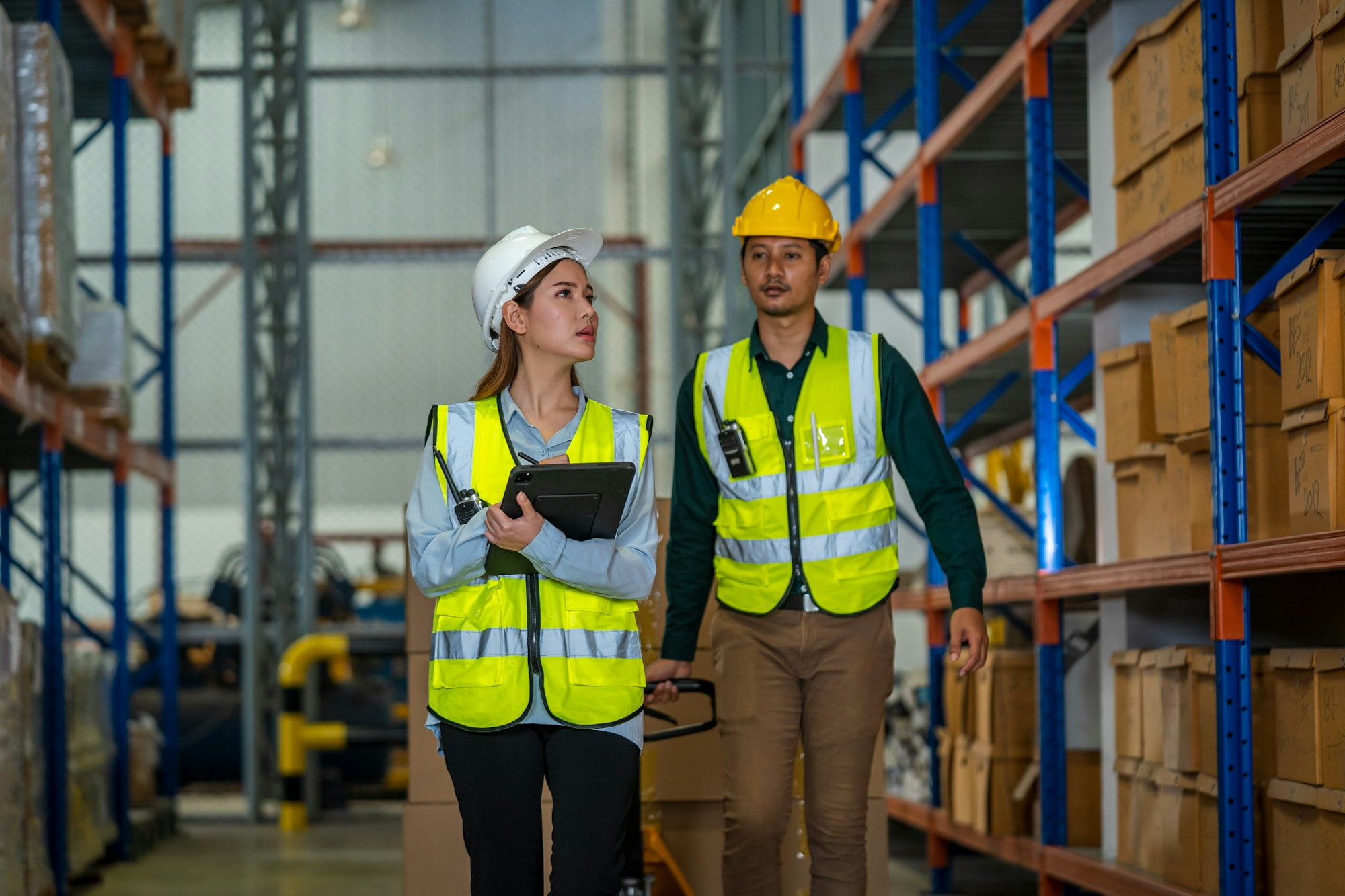 Warehouse employees with Inventory checking software in the retail warehouse.