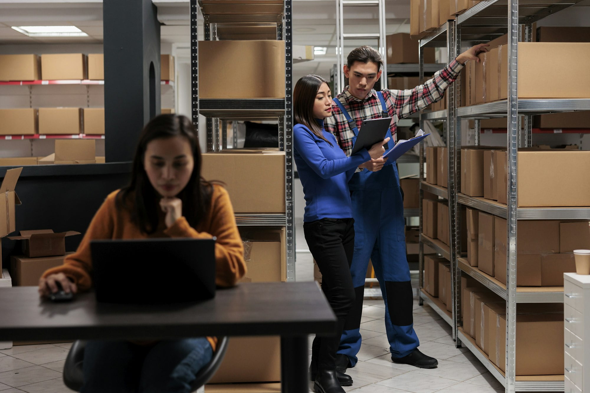 Warehouse worker and logistics manager doing products audit