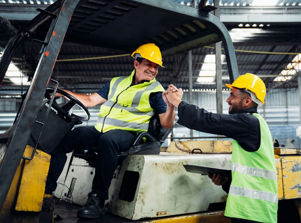 Industrious Engineer Operating Forklift in Warehouse. Efficient Forklift Driving in Factory.